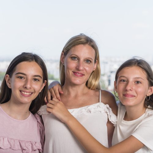 happy-mother-two-daughters-hugging