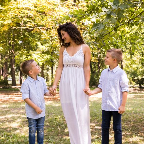 mother-taking-walk-park-with-her-sons_23-2148242462